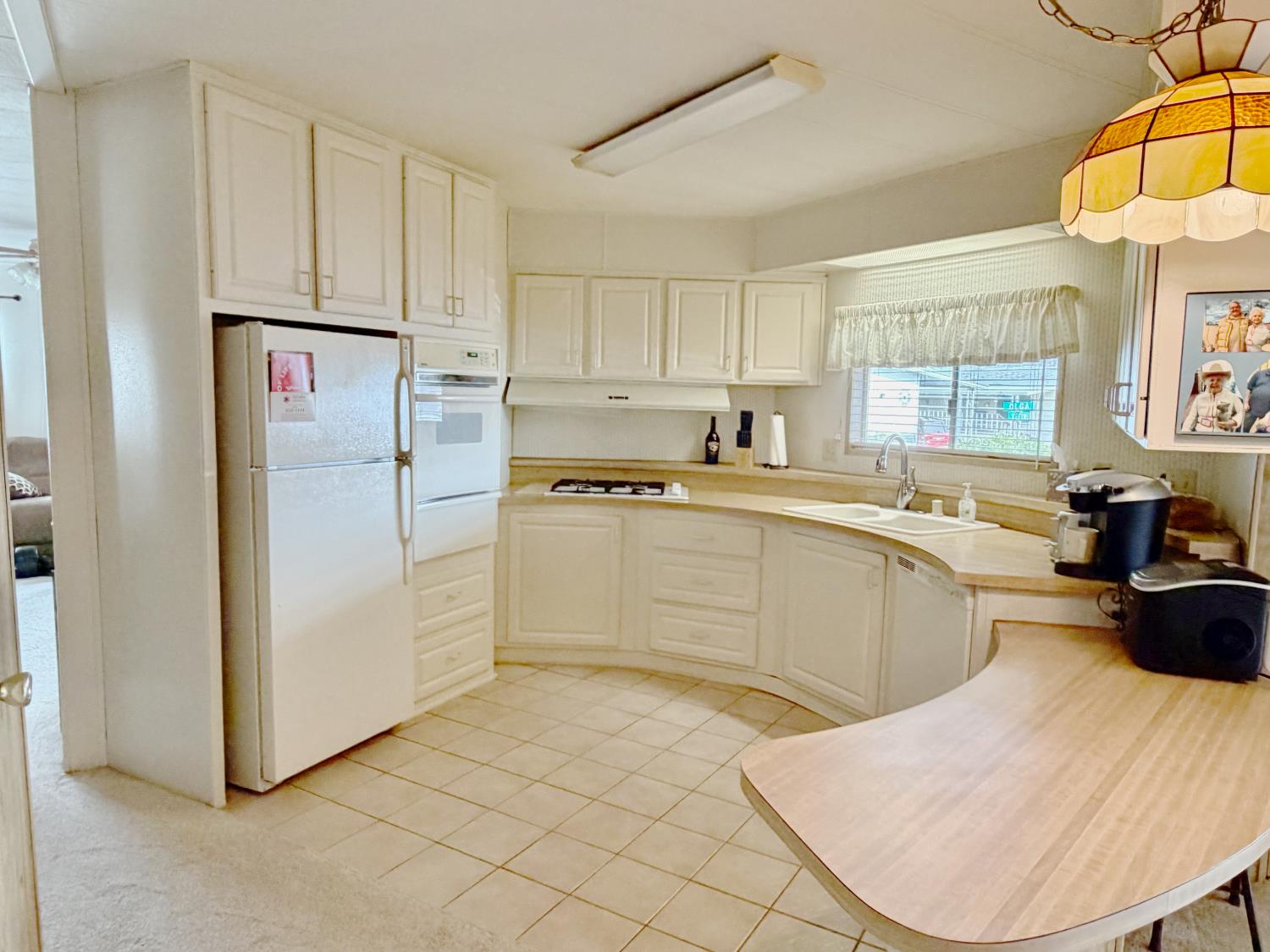68 Yefim Roseville, CA 95661 - Photo 7 of 35 a kitchen with a sink a refrigerator and cabinets