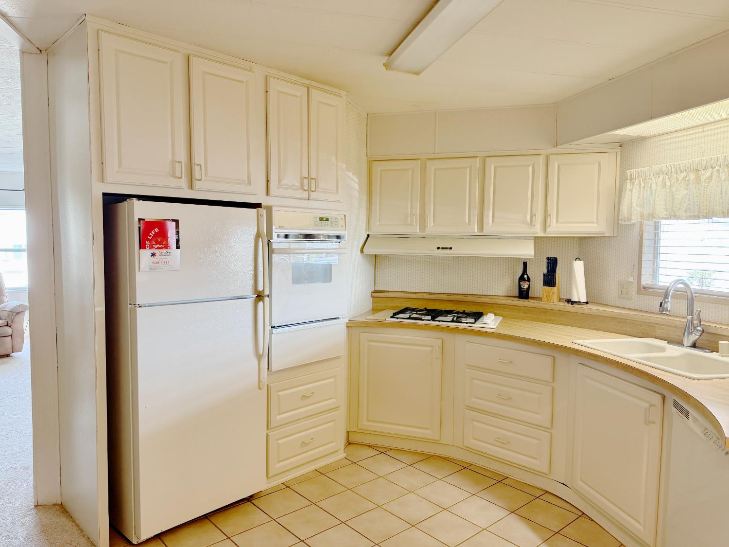 68 Yefim Roseville, CA 95661 - Photo 8 of 35 a kitchen with white cabinets and white appliances
