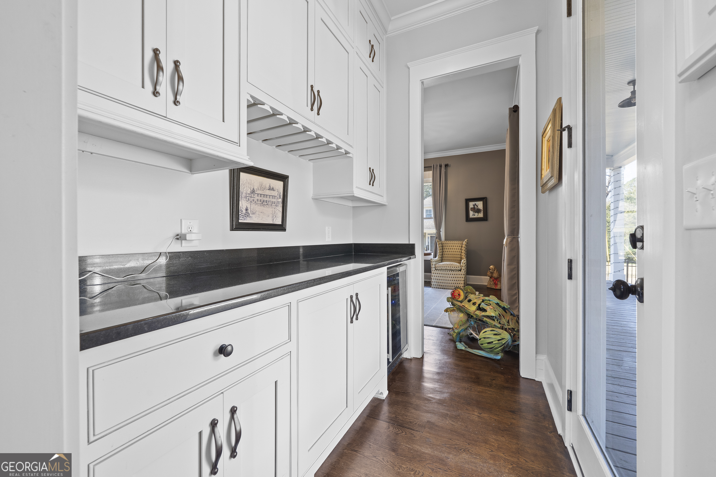 855 Jasper Street Madison, GA 30650 - Photo 12 of 46 a hallway with white cabinets and chandelier
