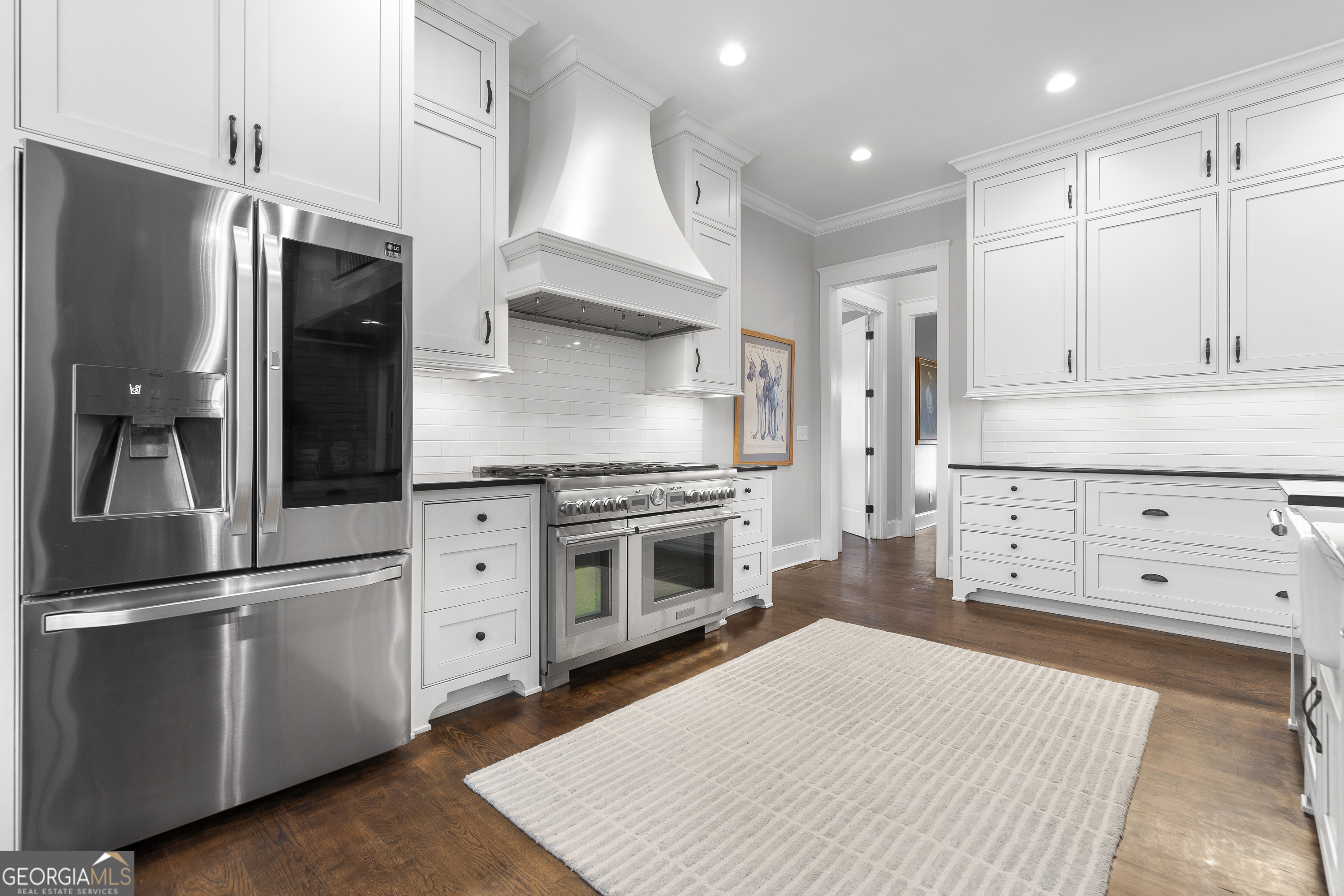 855 Jasper Street Madison, GA 30650 - Photo 13 of 46 a kitchen with stainless steel appliances a refrigerator sink and cabinets