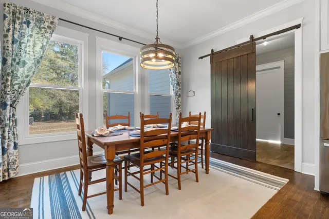 a view of a dining room with furniture window and wooden floor