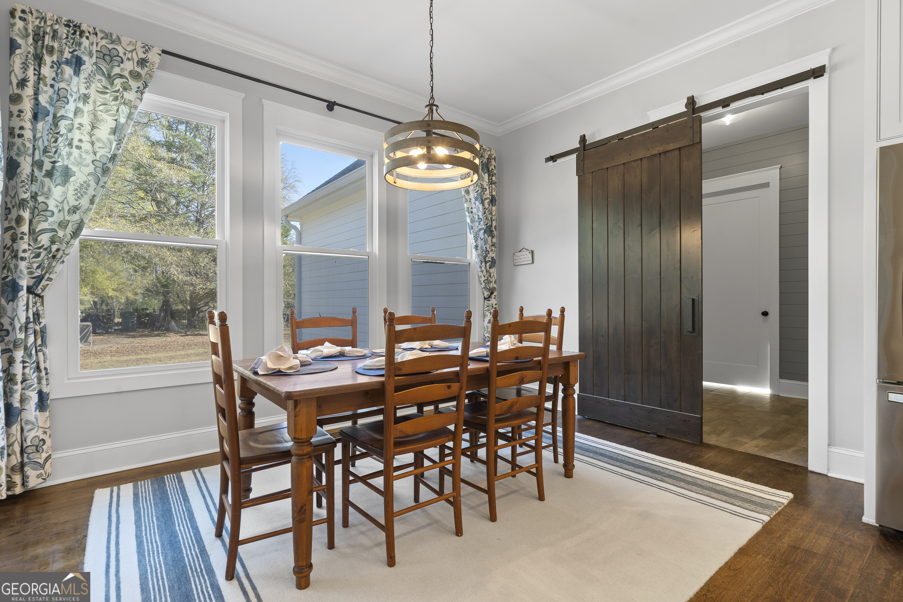 855 Jasper Street Madison, GA 30650 - Photo 18 of 46 a view of a dining room with furniture window and wooden floor