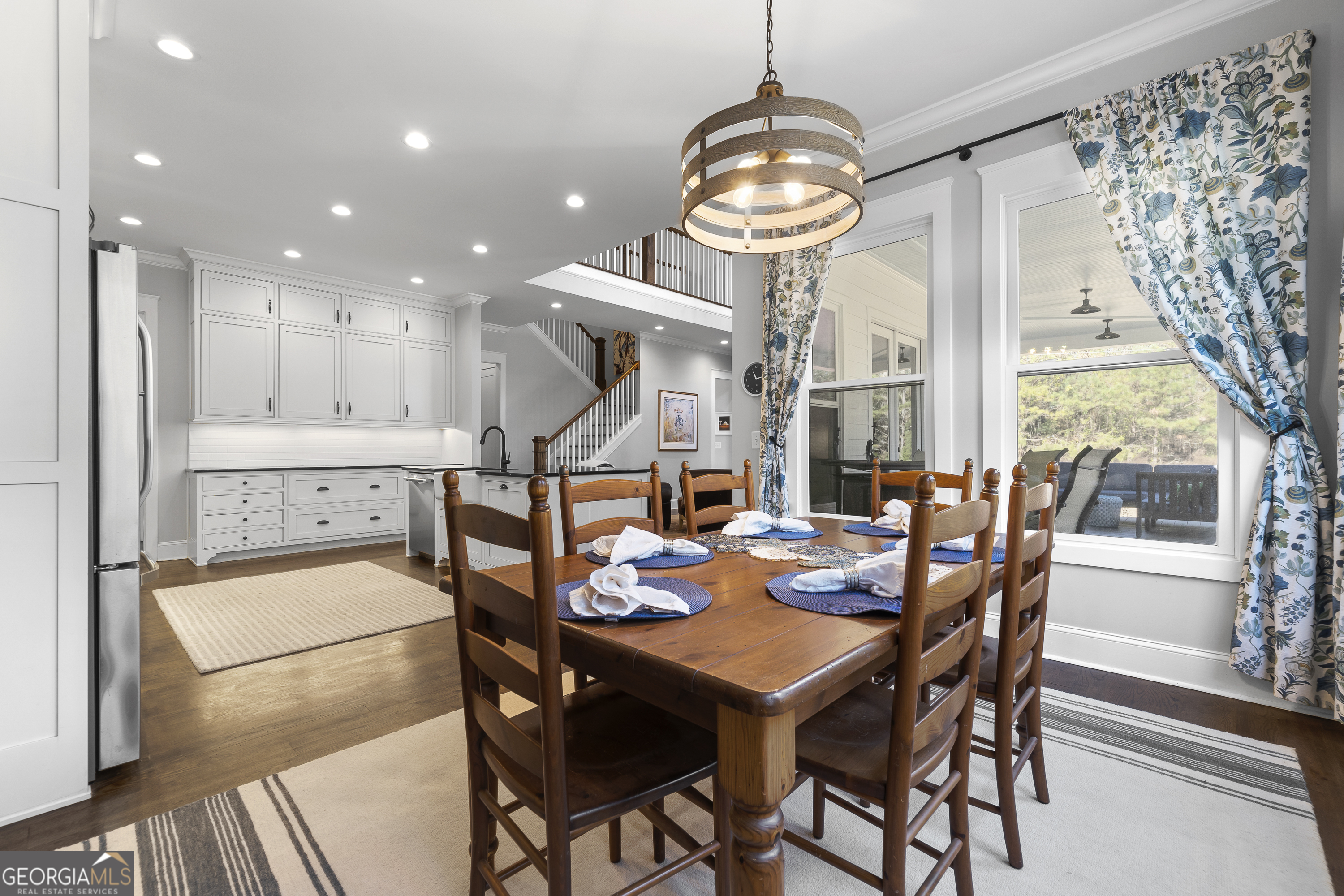 855 Jasper Street Madison, GA 30650 - Photo 20 of 46 a view of a dining room with furniture a chandelier and wooden floor