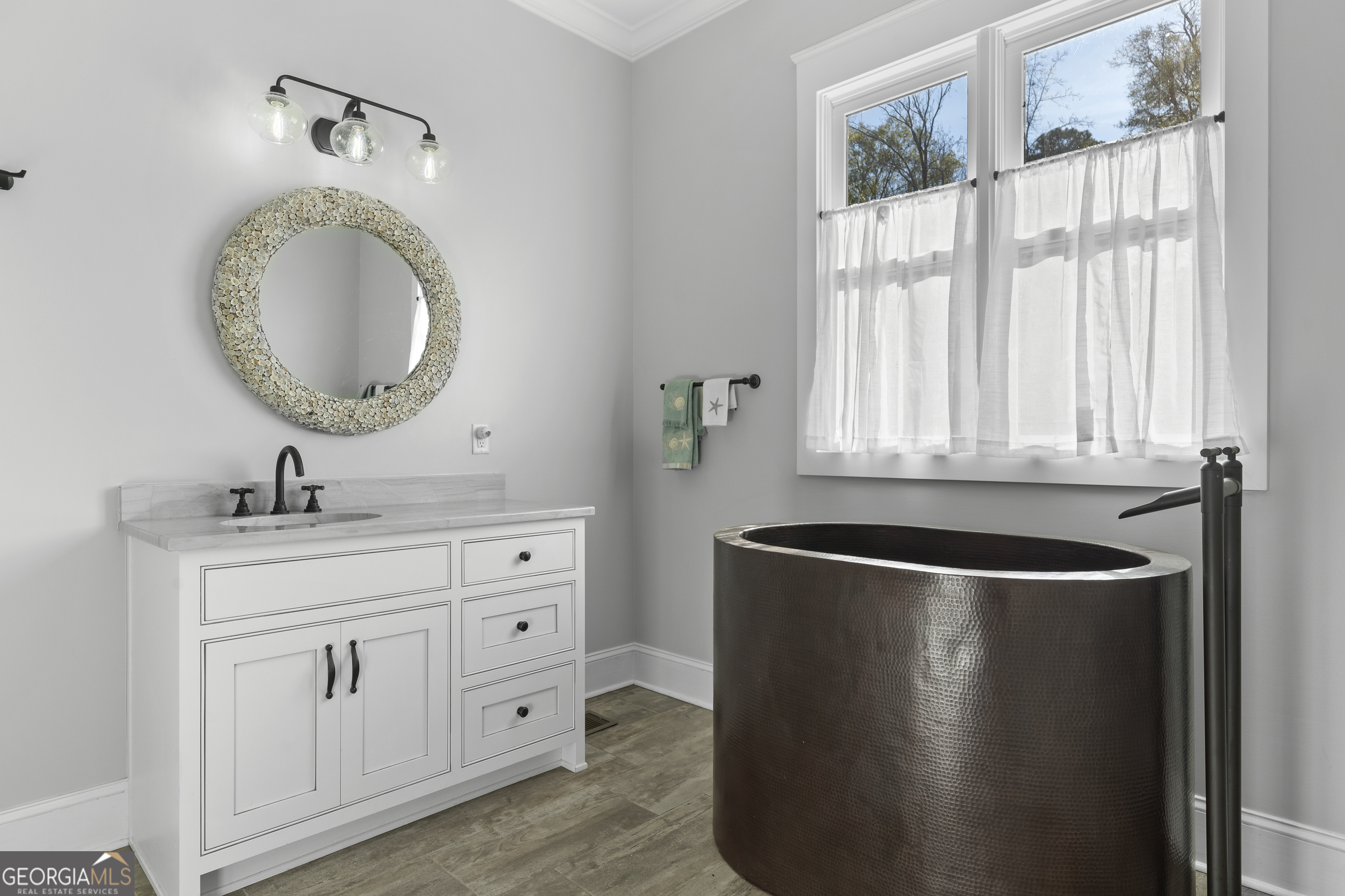 855 Jasper Street Madison, GA 30650 - Photo 23 of 46 a bathroom with a granite countertop sink a mirror and a