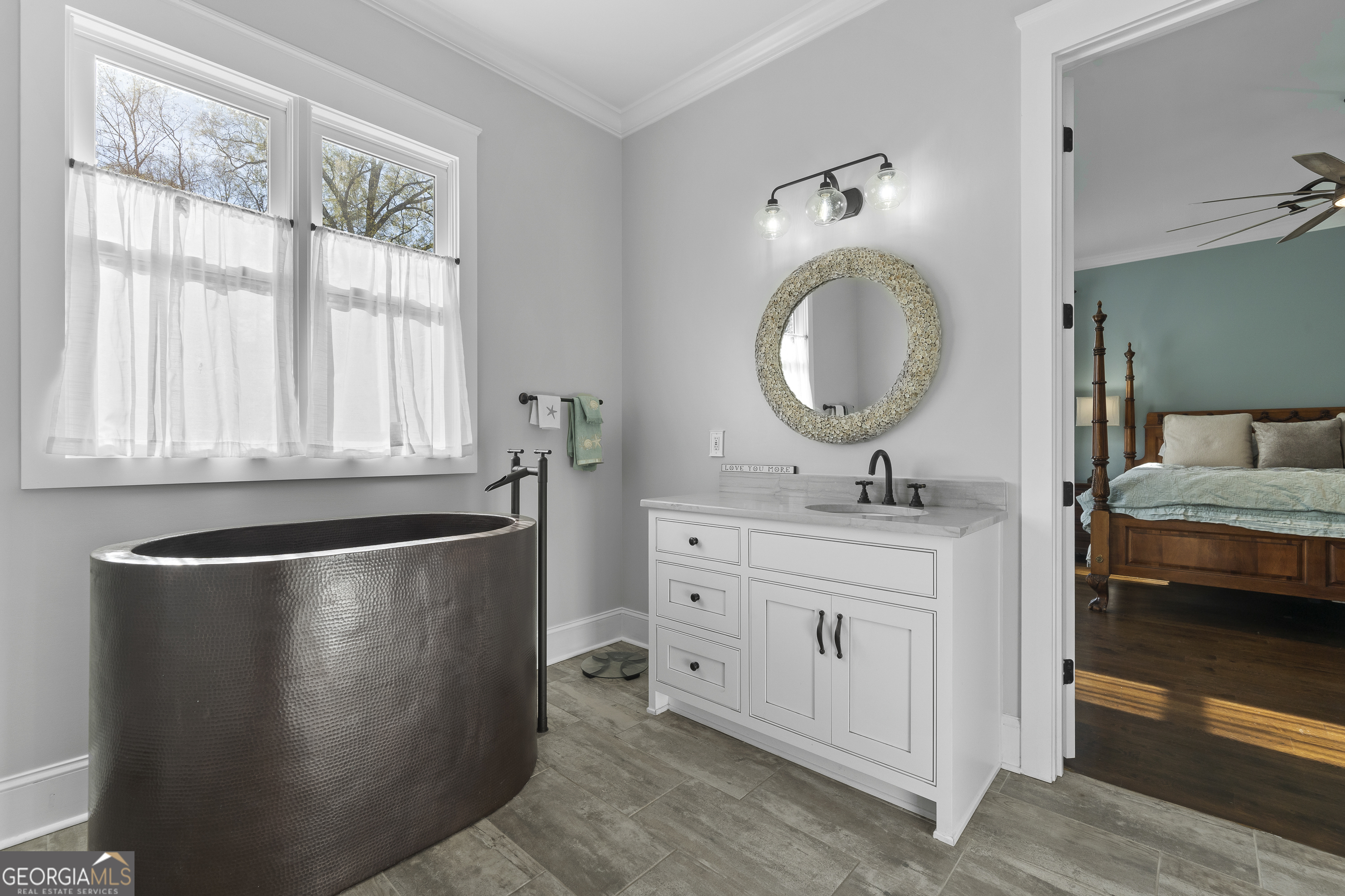 855 Jasper Street Madison, GA 30650 - Photo 24 of 46 a bathroom with a sink and a mirror