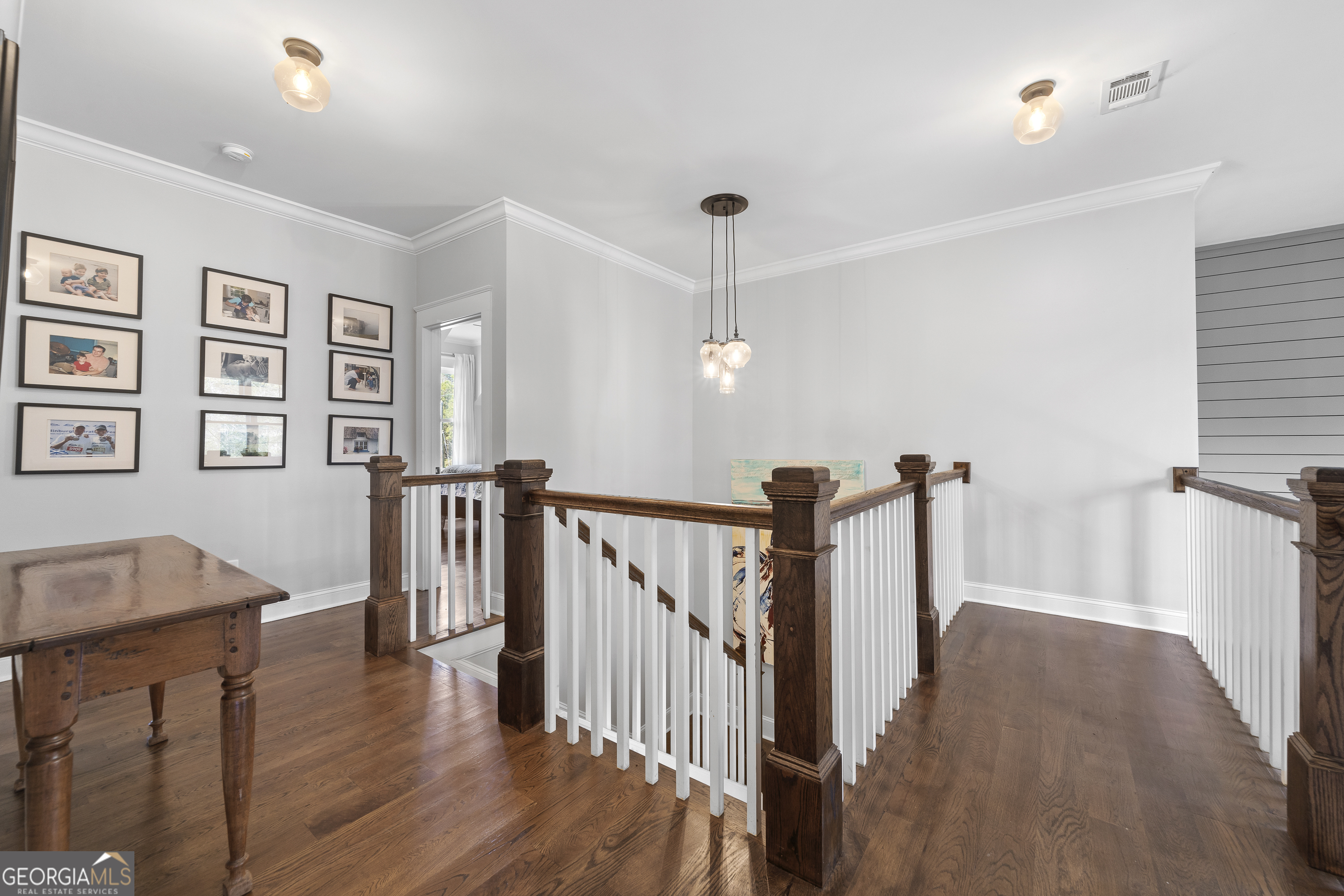 855 Jasper Street Madison, GA 30650 - Photo 29 of 46 a view of a hallway with wooden floor and staircase