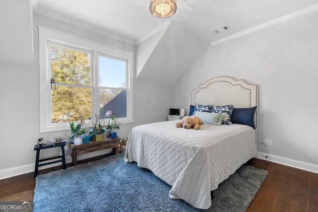 a bedroom with bed and a window