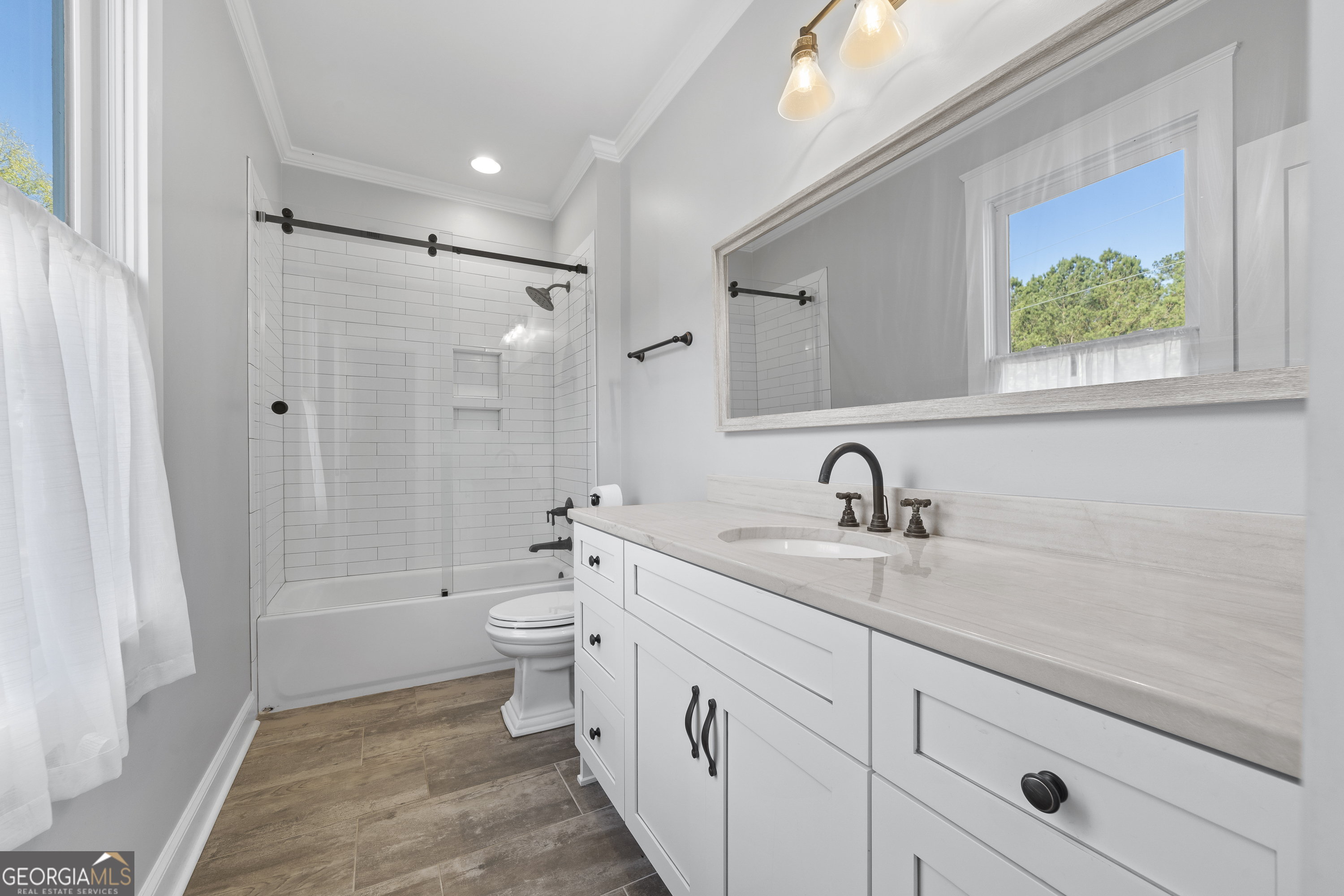 855 Jasper Street Madison, GA 30650 - Photo 35 of 46 a view of bathroom with a sink a toilet and shower