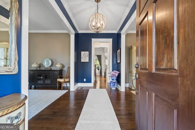 a very nice looking dining room with a fireplace and chandelier