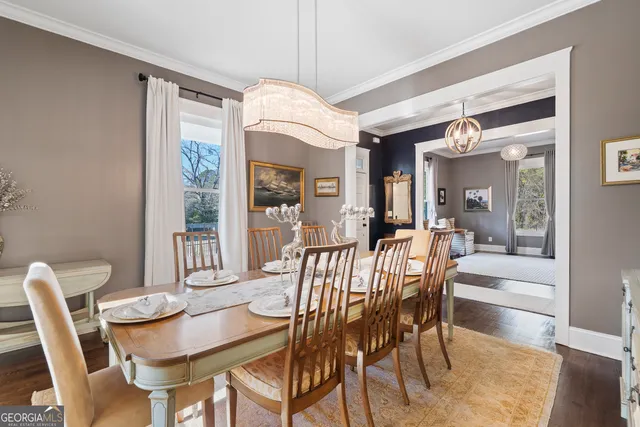 a view of a dining room with furniture a chandelier and wooden floor