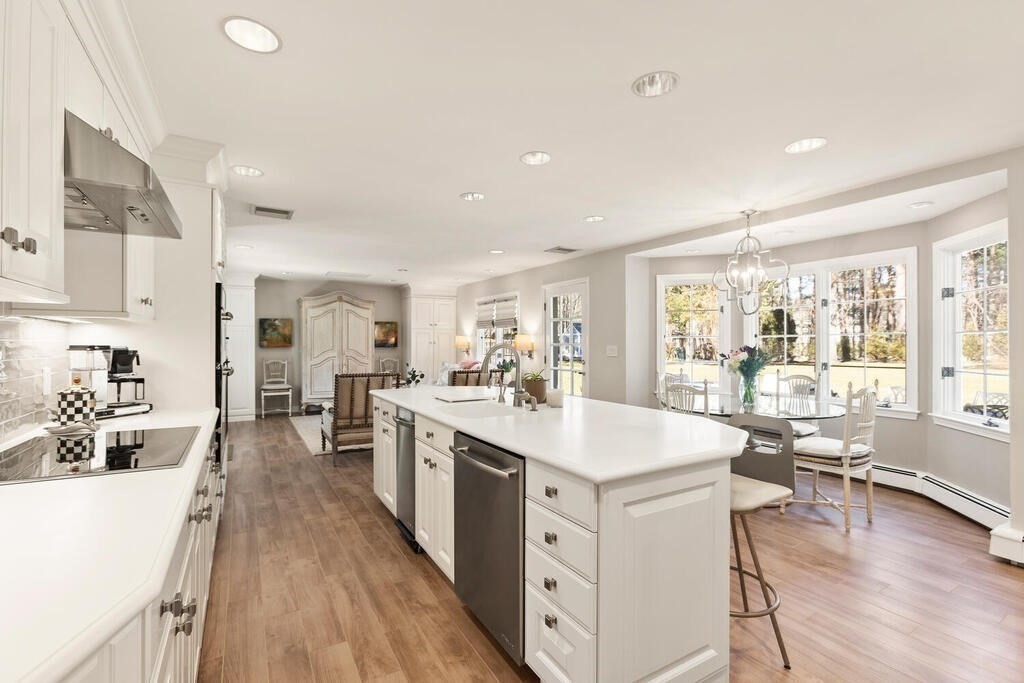 70 Windsor Road Needham, MA 02492 - Photo 8 of 35 a large white kitchen with a large window and stainless steel appliances