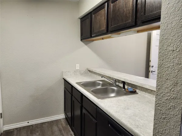 a kitchen with a sink and cabinets