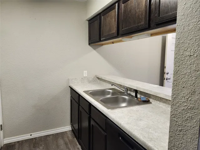 a kitchen with a sink and cabinets