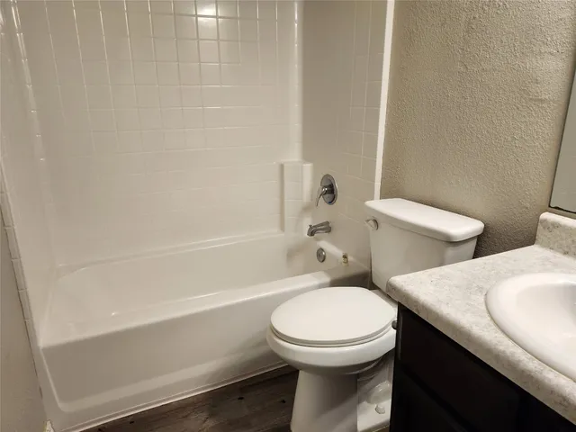 a bathroom with a toilet a sink and bathtub