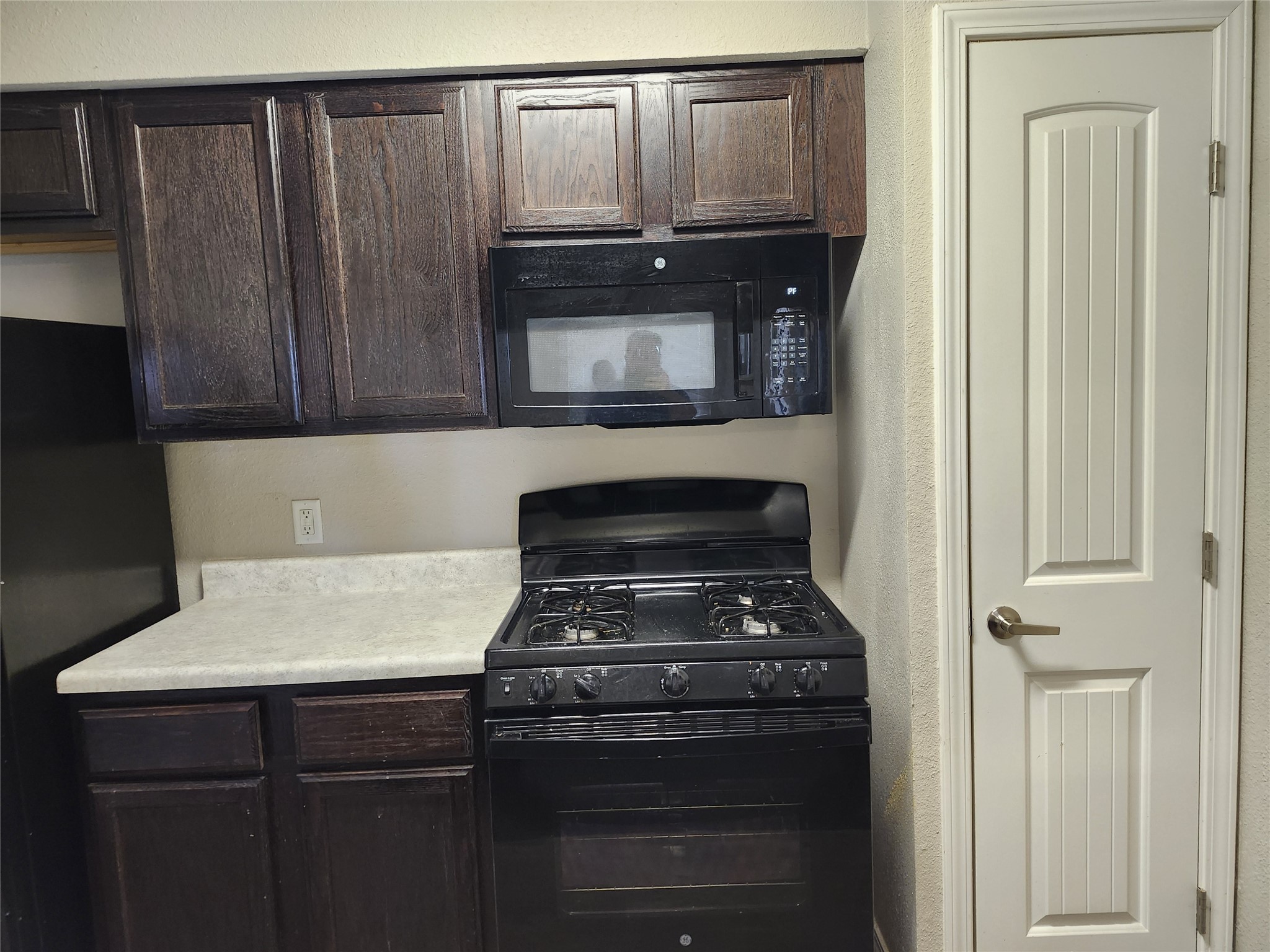 1000 South 8th Street Buckholts, TX 76518 - Photo 10 of 13 a kitchen with a stove and a microwave