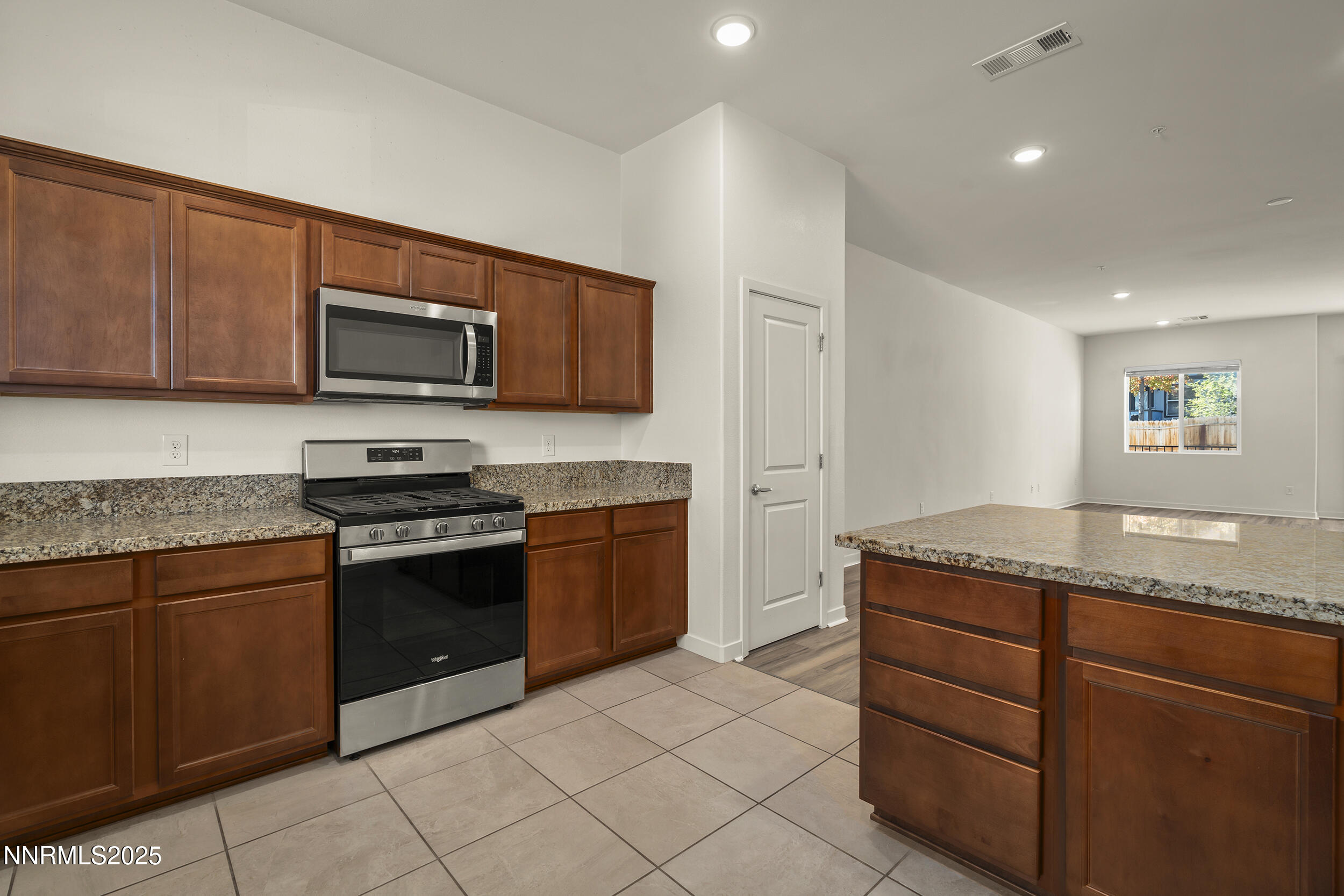 5013 Cavestone Road Sun Valley, NV 89433 - Photo 13 of 21 a kitchen with granite countertop cabinets stainless steel appliances and a counter space