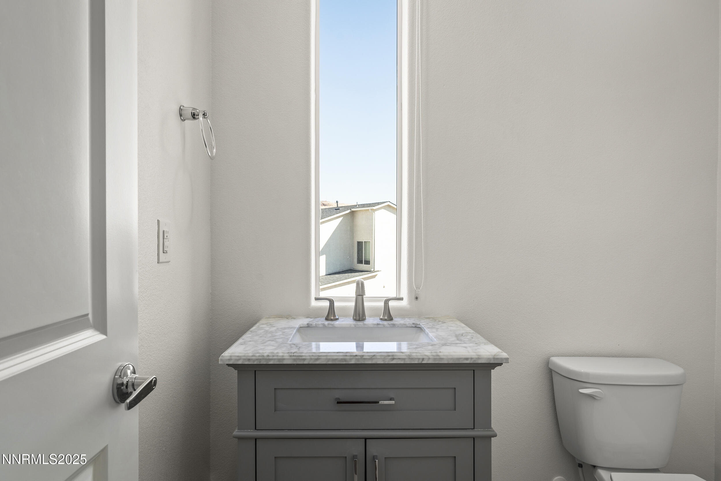 5013 Cavestone Road Sun Valley, NV 89433 - Photo 14 of 21 a bathroom with a granite countertop toilet sink and mirror