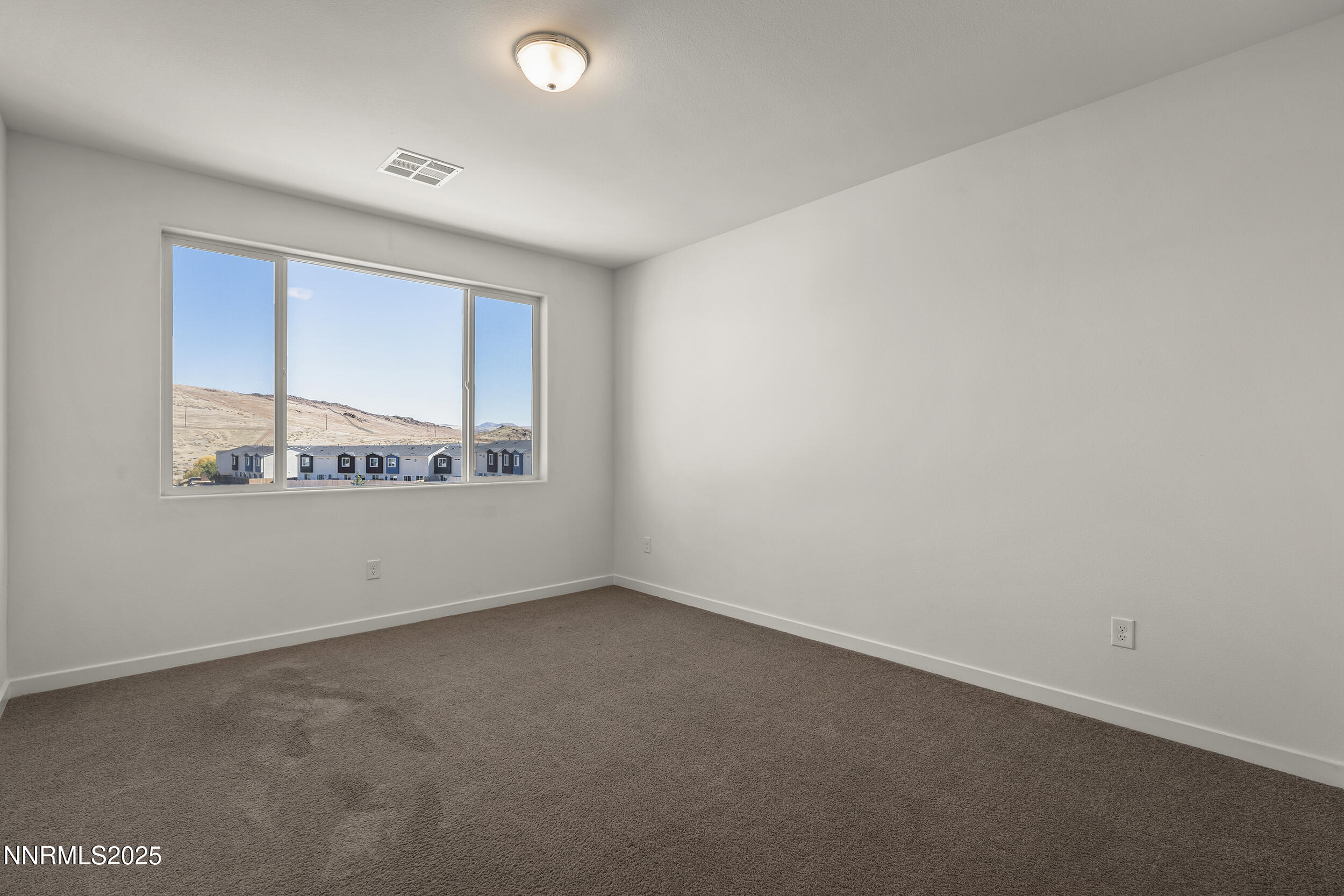 5013 Cavestone Road Sun Valley, NV 89433 - Photo 15 of 21 an empty room with a window