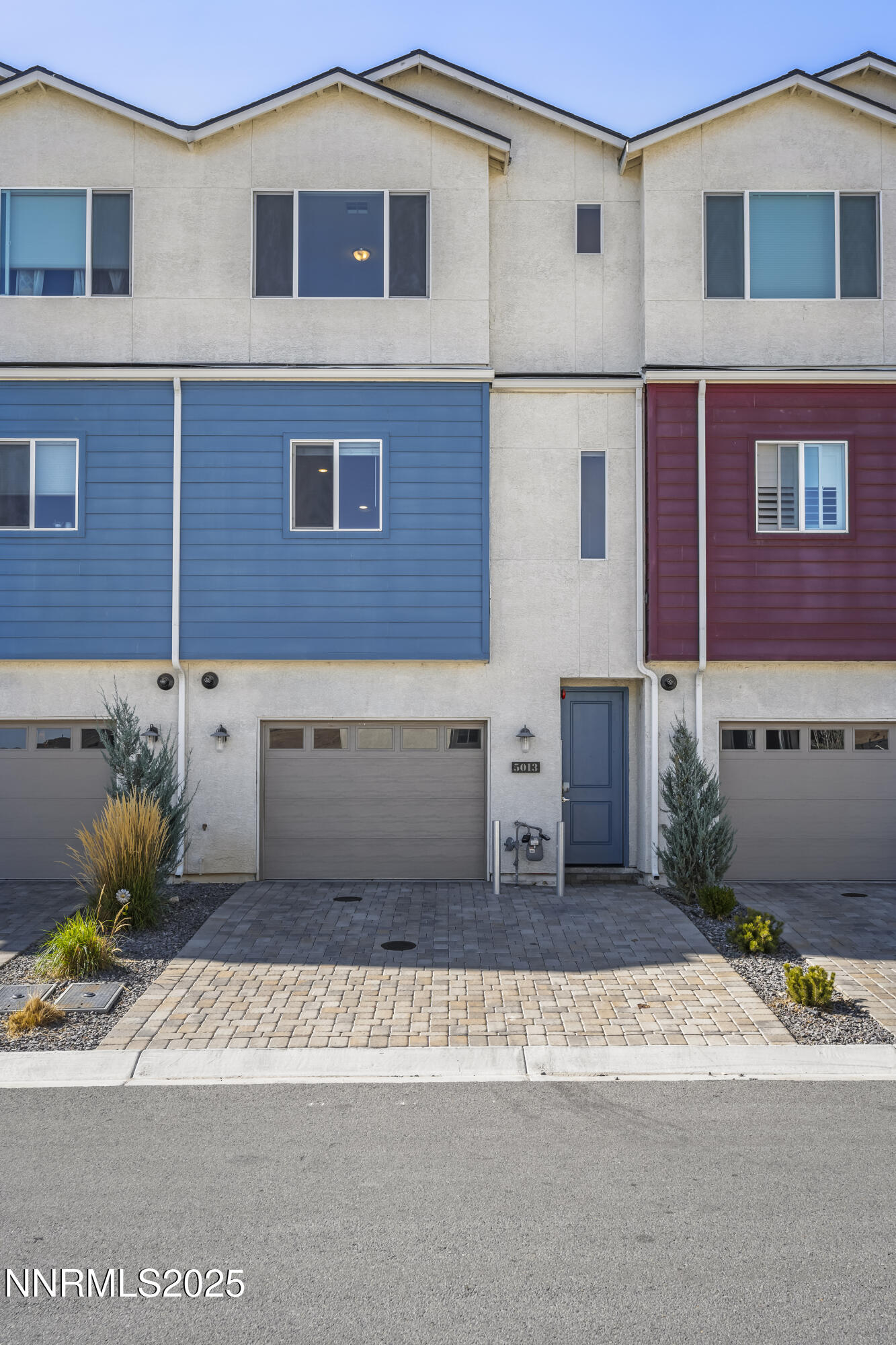 5013 Cavestone Road Sun Valley, NV 89433 - Photo 2 of 21 a front view of a house with a yard and a garage