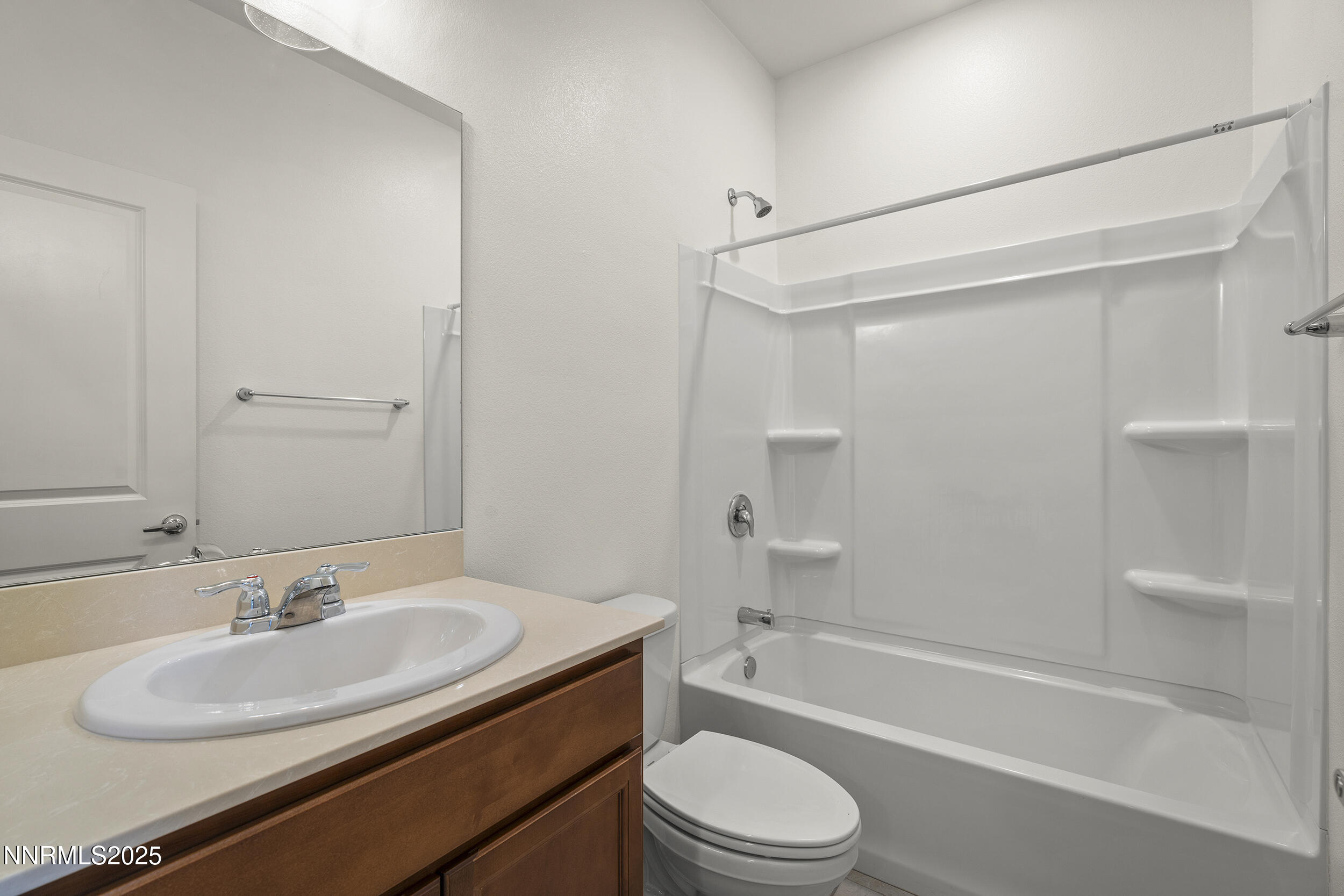 5013 Cavestone Road Sun Valley, NV 89433 - Photo 21 of 21 a bathroom with a granite countertop sink toilet and shower