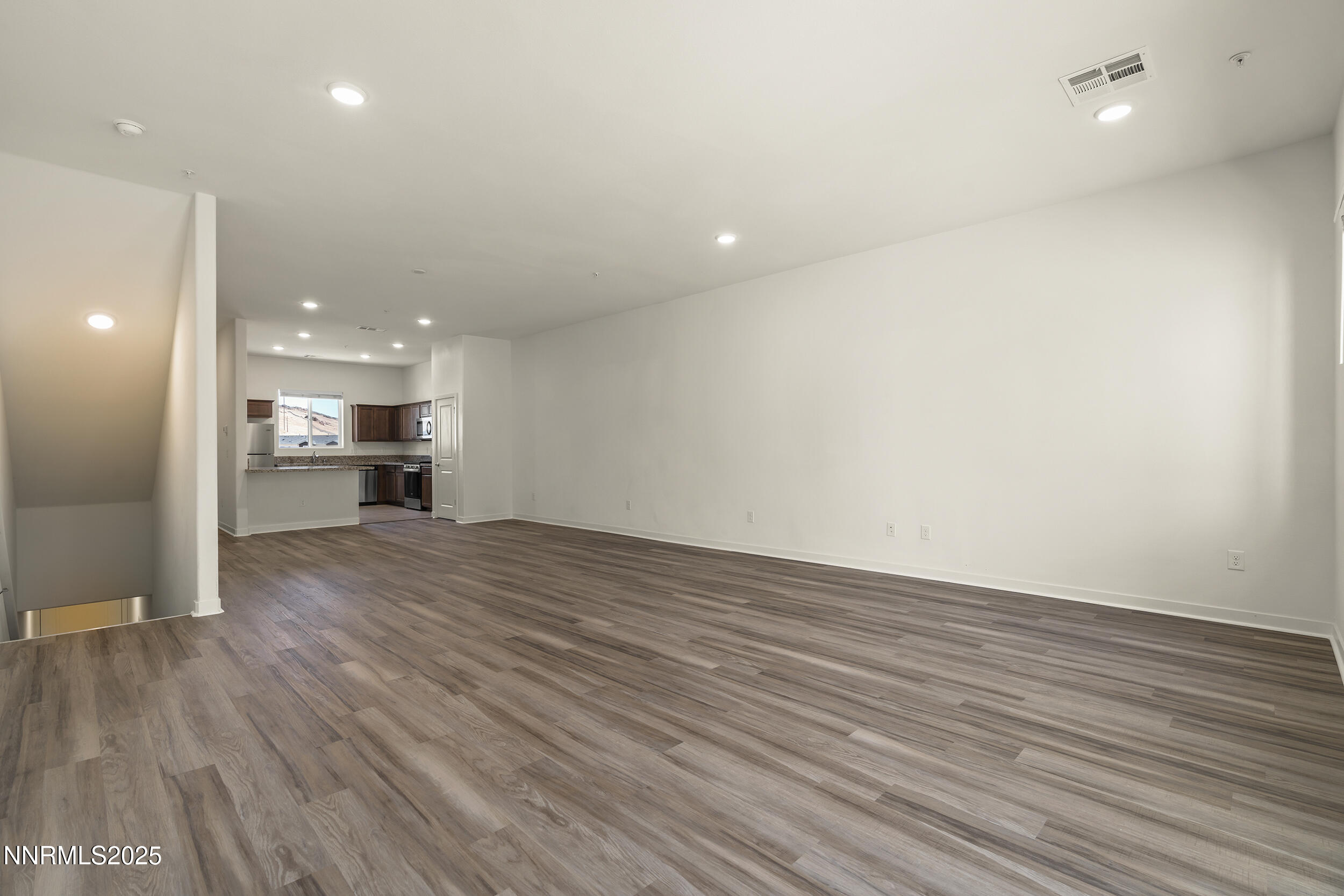 5013 Cavestone Road Sun Valley, NV 89433 - Photo 4 of 21 a view of empty room with wooden floor