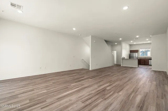 a view of kitchen and hall with wooden floor