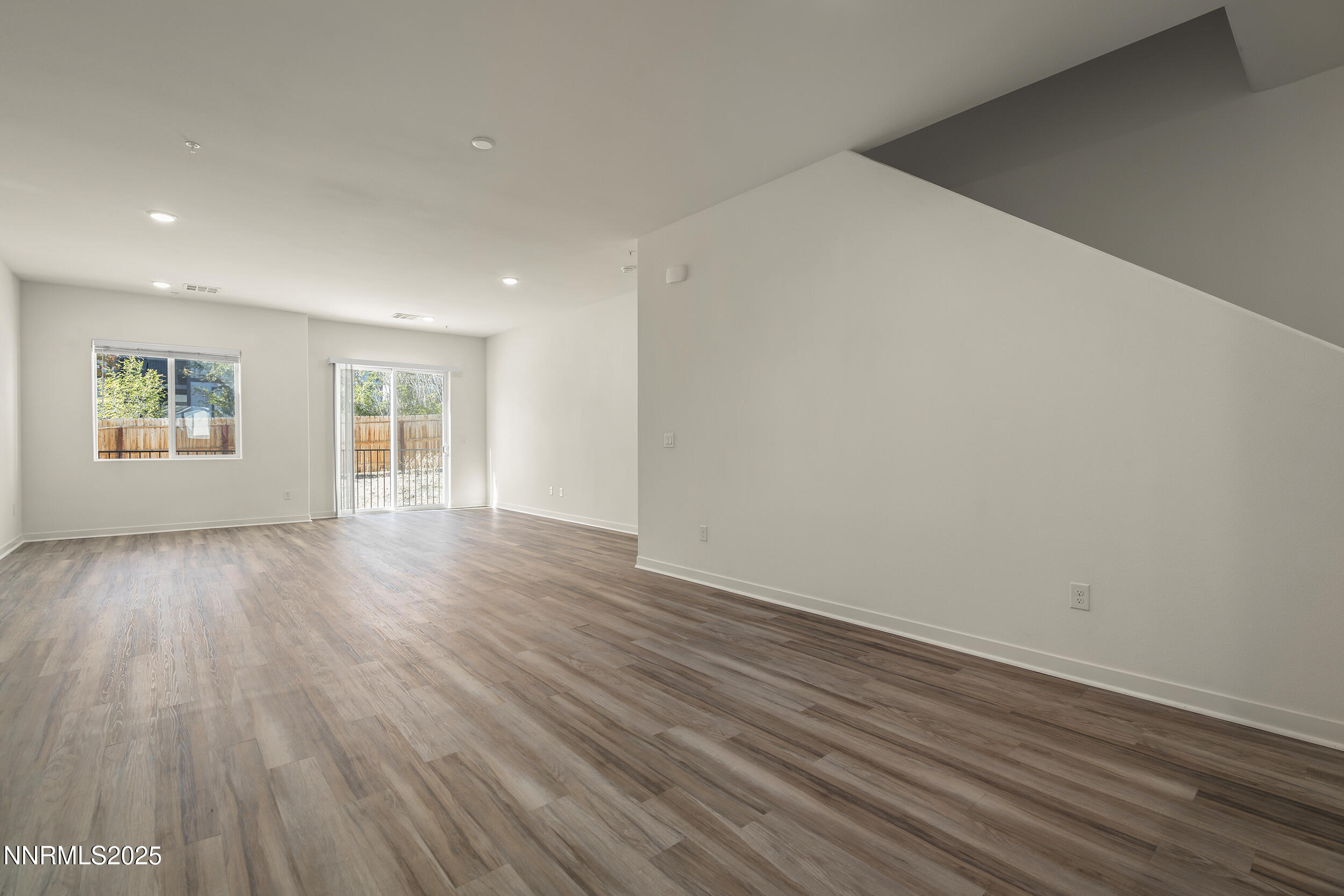 5013 Cavestone Road Sun Valley, NV 89433 - Photo 10 of 21 a view of an empty room with wooden floor and a window