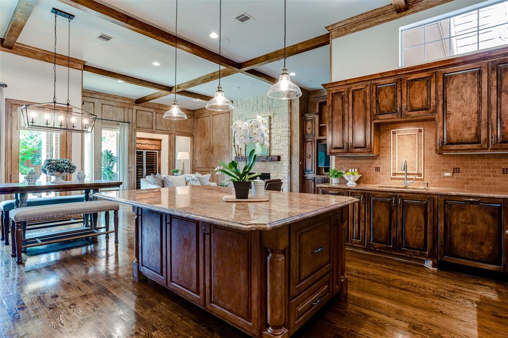 a kitchen with stainless steel appliances granite countertop a sink and wooden cabinets