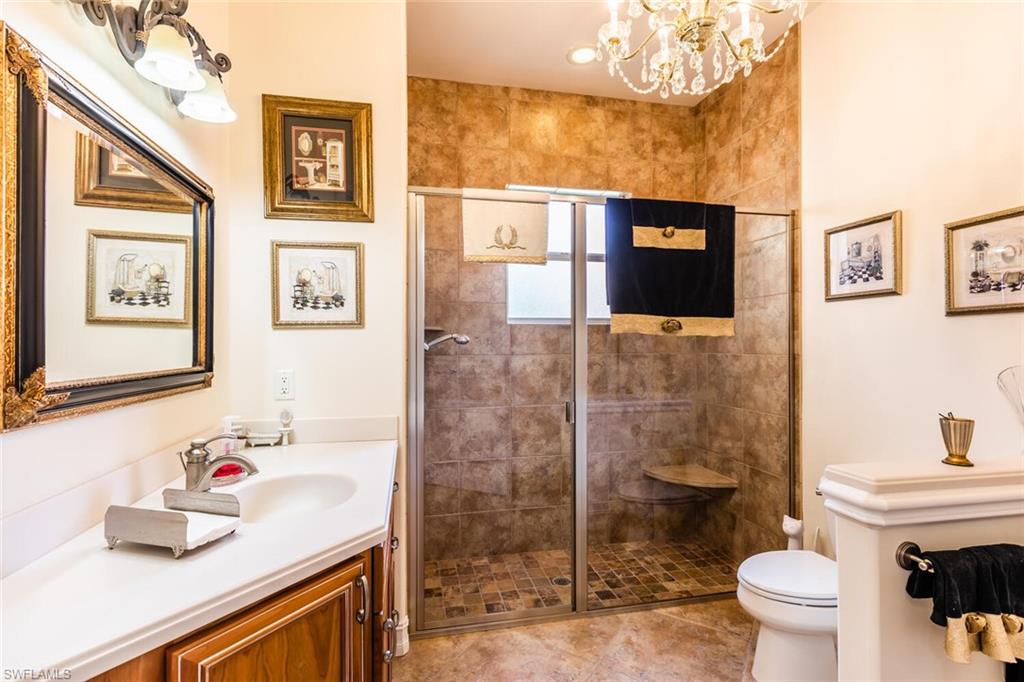 7025 Kiwi Place Naples, FL 34113 - Photo 14 of 28 a bathroom with a sink and a mirror
