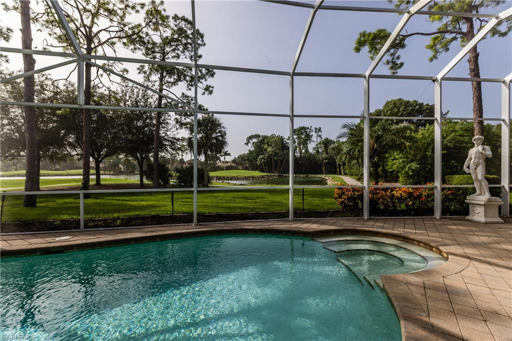 7025 Kiwi Place Naples, FL 34113 - Photo 19 of 28 a view of a house with a backyard