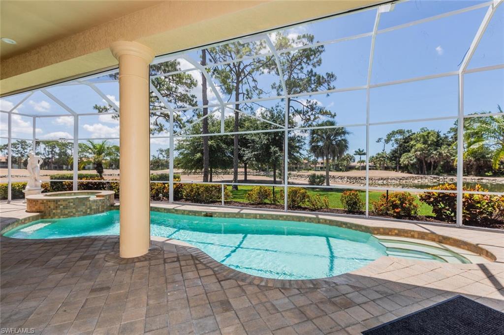 7025 Kiwi Place Naples, FL 34113 - Photo 20 of 28 a view of a swimming pool with a yard