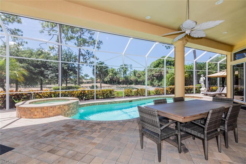 7025 Kiwi Place Naples, FL 34113 - Photo 21 of 28 a view of a patio with a table chairs and a backyard
