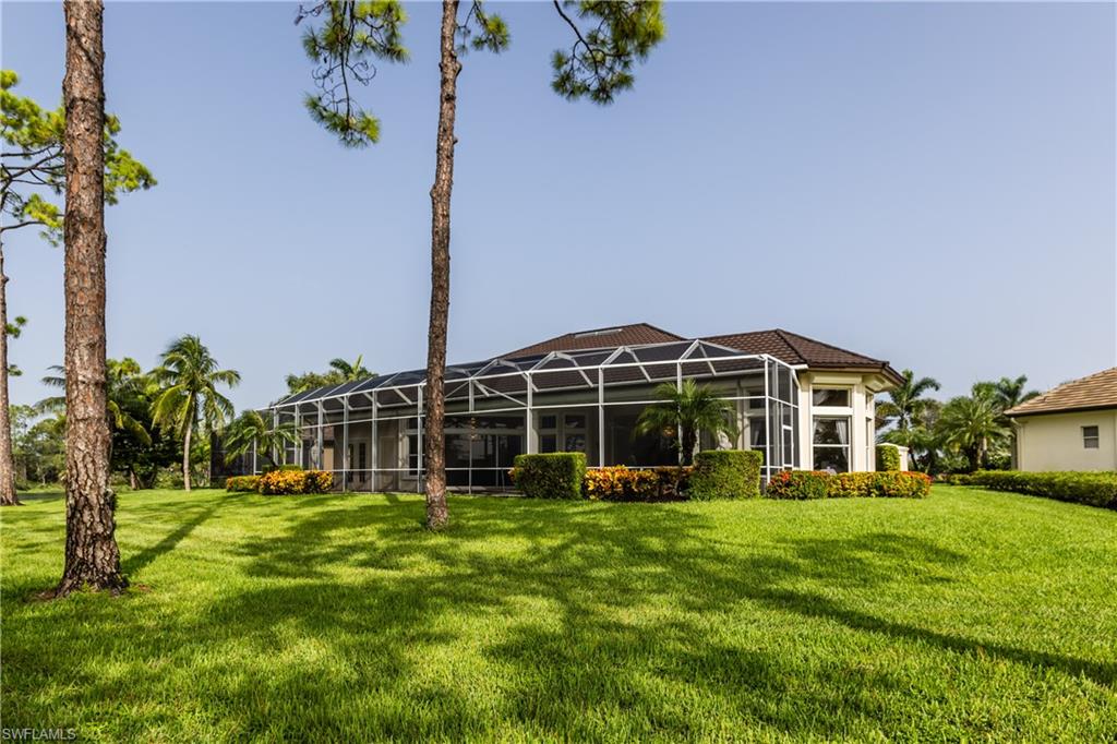 7025 Kiwi Place Naples, FL 34113 - Photo 24 of 28 a view of a house with a yard