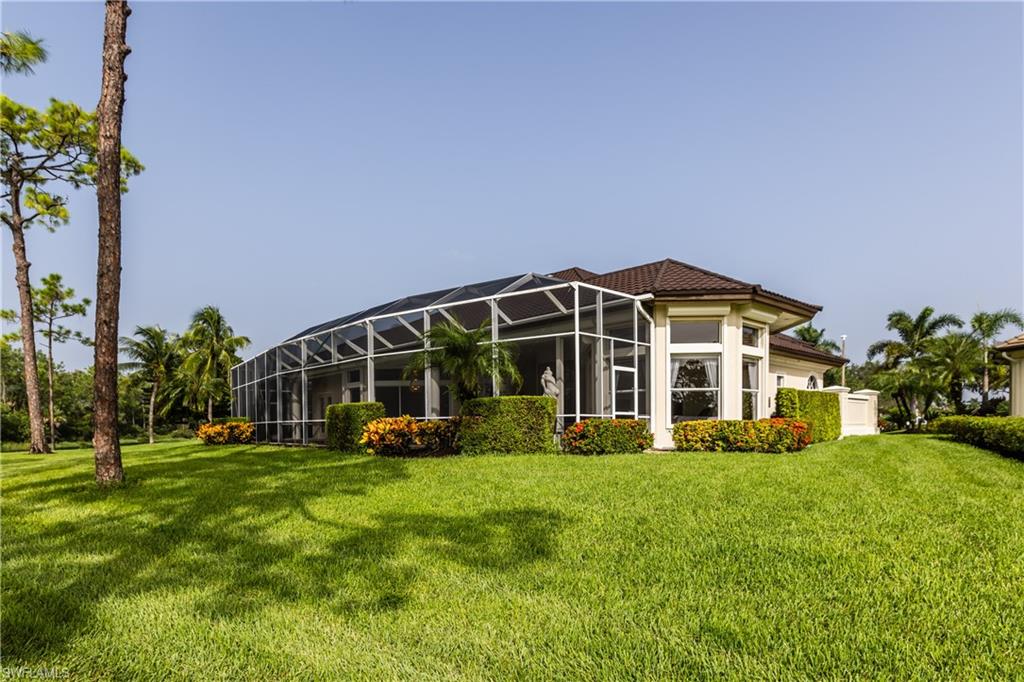 7025 Kiwi Place Naples, FL 34113 - Photo 25 of 28 a view of a house with a big yard and potted plants