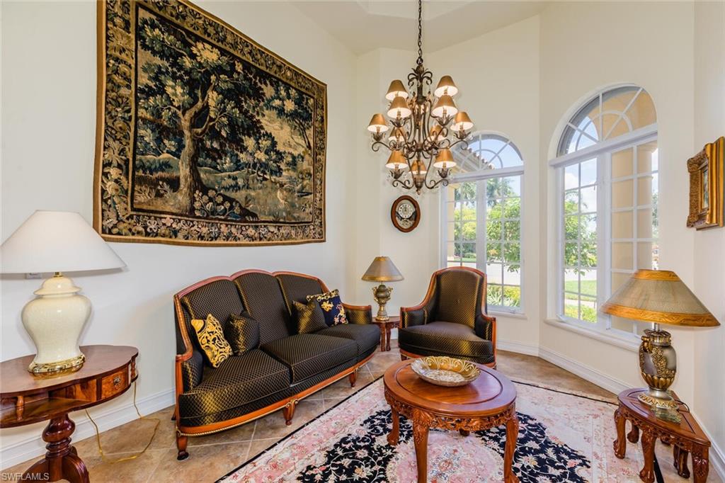 7025 Kiwi Place Naples, FL 34113 - Photo 7 of 28 a living room with furniture and a large window