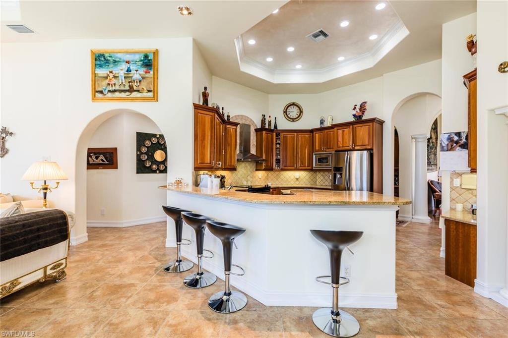 7025 Kiwi Place Naples, FL 34113 - Photo 9 of 28 a living room with furniture and a flat screen tv