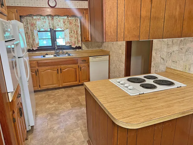 a kitchen with a stove and a refrigerator