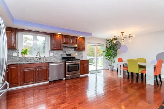 a kitchen with granite countertop stainless steel appliances and wooden cabinets