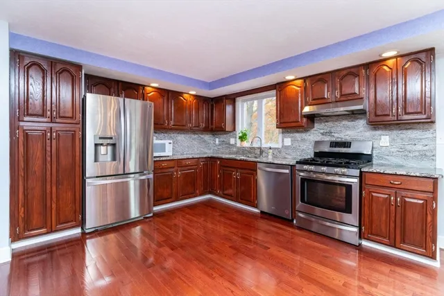 a living room with furniture a fireplace and dining table
