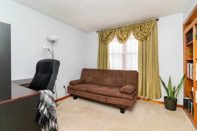 a living room with a couch and a book shelf