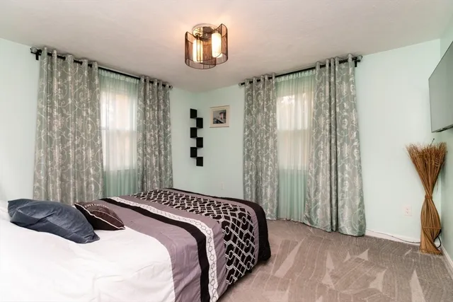 a bedroom with a bed and a tv