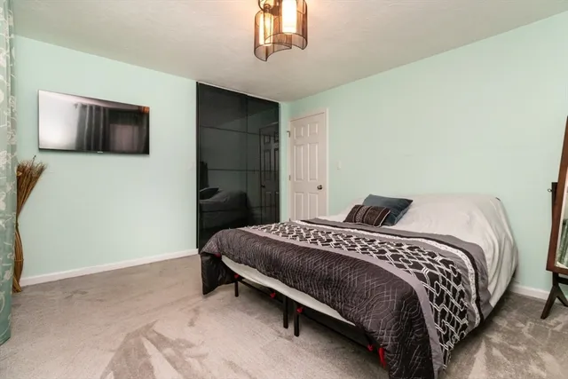 a bedroom with a bed and a mirror