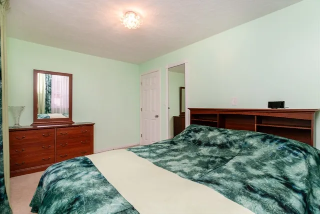a bathroom with a granite countertop sink a toilet and a mirror
