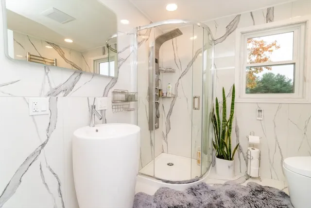 a white bath tub sitting next to a white sink