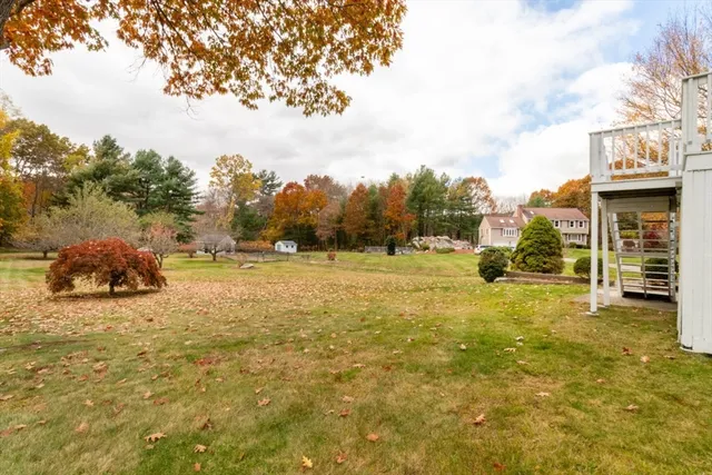 a view of yard with swimming pool and trees