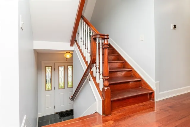 a living room with furniture a flat screen tv and a window
