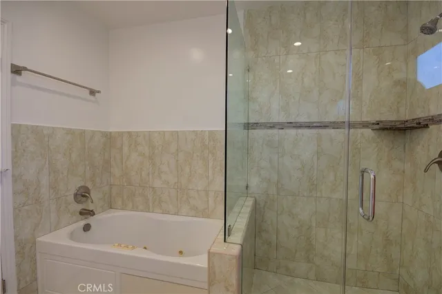 a bathroom with a bathtub and a shower