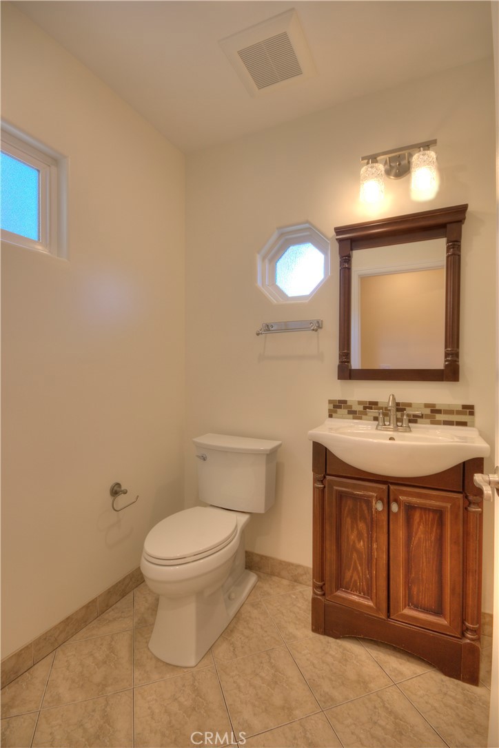 1367 East Windsor Road Glendale, CA 91205 - Photo 17 of 21 a bathroom with a toilet sink and mirror