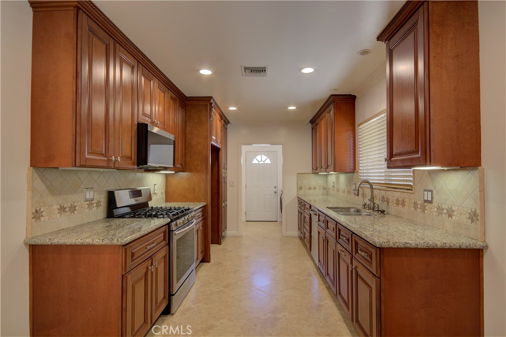 1367 East Windsor Road Glendale, CA 91205 - Photo 2 of 21 a kitchen with stainless steel appliances granite countertop a sink stove and cabinets