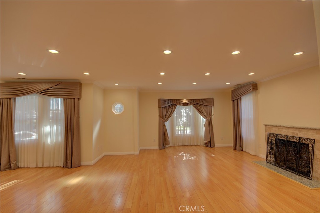 1367 East Windsor Road Glendale, CA 91205 - Photo 6 of 21 a view of empty room with wooden floor and fireplace